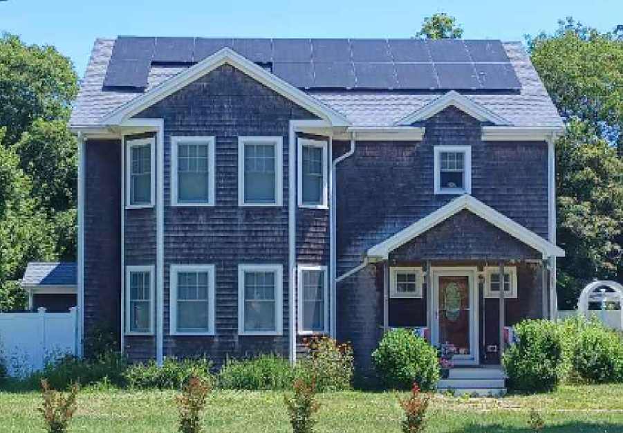 Here is an image of a Massachusetts home with solar panels installed. The picture shows the house from the front and the solar panels on the top of the roof. Our Massachusetts solar installer works all over New England.