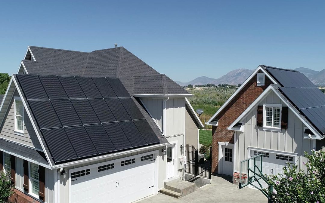 The picture shows two solar panel installations in Rhode Island, installed on two houses, one next to the other.