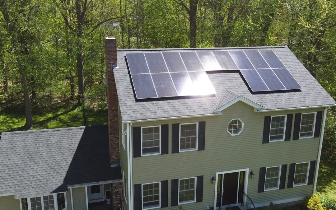 Here is an image of residential solar panels in NH, taken from a drone camera. We are a New Hampshire solar installer and can install solar panels on the roof of a home or elsewhere on the property.