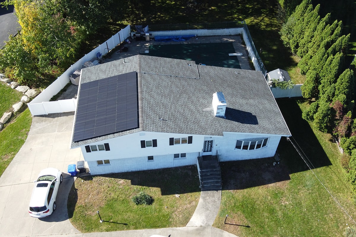 Here is an image of Massachusetts residential solar panels, taken from a drone camera. The solar installation is on the roof of a house in MA.