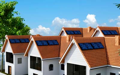 This is an image of newly built houses with solar panels installed on their roofs.
