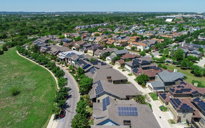 This is an image of a community with solar panel roofs as community solar projects are emerging as a promising solution.